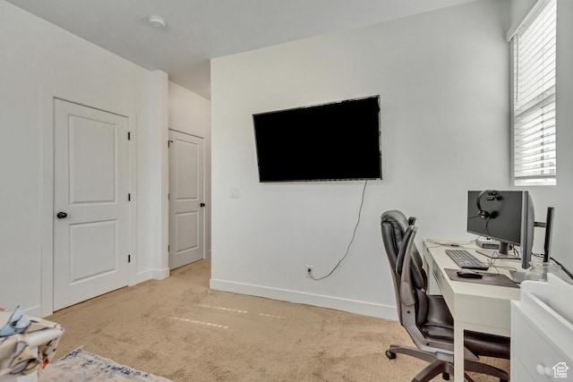 carpeted office space featuring baseboards