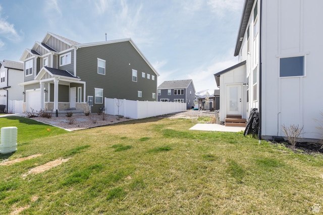view of yard with entry steps, a residential view, and fence