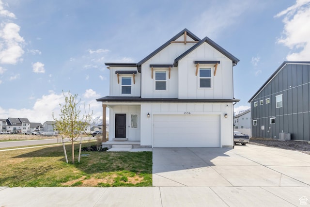 modern farmhouse featuring board and batten siding, a garage, cooling unit, a front lawn, and driveway
