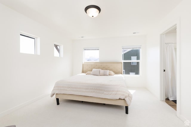 bedroom with carpet floors and baseboards