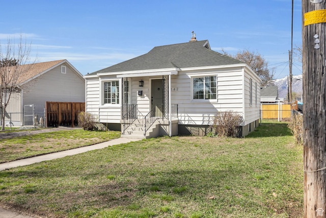 142 Ray St, Ogden, UT 84404 - bungalow featuring a front yard, fence, and a shingled roof