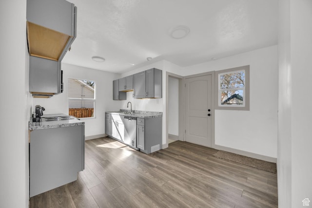 142 Ray St, Ogden, UT 84404 - kitchen with baseboards, a sink, gray cabinetry, wood finished floors, and stainless steel dishwasher