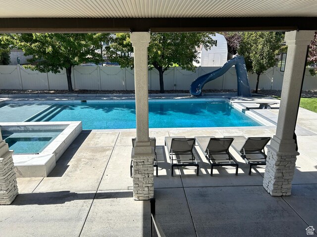 10124 S Autumn Breeze Ln W, South Jordan, UT 84009 - view of pool with a fenced backyard, a water slide, an in ground hot tub, and a patio area