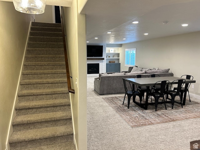 10124 S Autumn Breeze Ln W, South Jordan, UT 84009 - dining area with baseboards, recessed lighting, stairway, a fireplace, and carpet