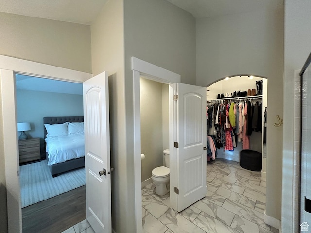 10124 S Autumn Breeze Ln W, South Jordan, UT 84009 - bathroom with a towering ceiling, baseboards, a spacious closet, toilet, and marble finish floor