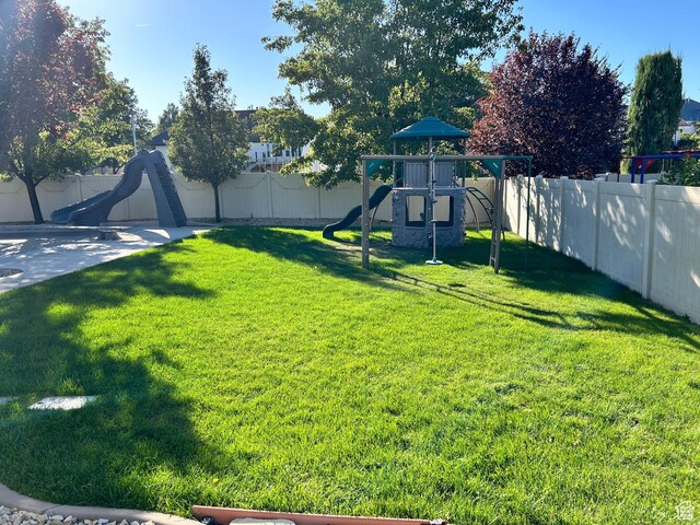 10124 S Autumn Breeze Ln W, South Jordan, UT 84009 - view of yard with a fenced backyard and a playground