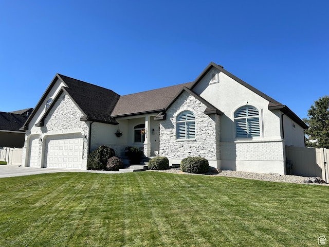 10124 S Autumn Breeze Ln W, South Jordan, UT 84009 - french country home featuring stone siding, a garage, a front yard, and fence