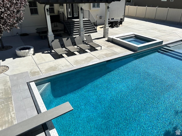 10124 S Autumn Breeze Ln W, South Jordan, UT 84009 - pool featuring a diving board, an outdoor fire pit, a patio area, fence, and an in ground hot tub