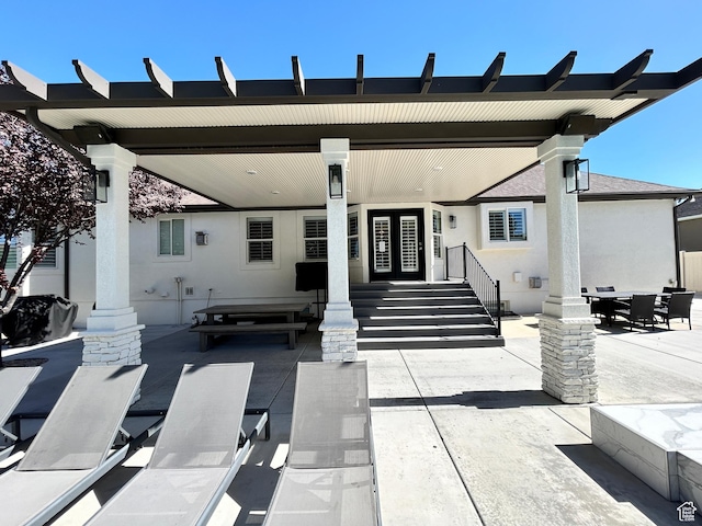 10124 S Autumn Breeze Ln W, South Jordan, UT 84009 - back of house with a patio area, outdoor dining area, and stucco siding