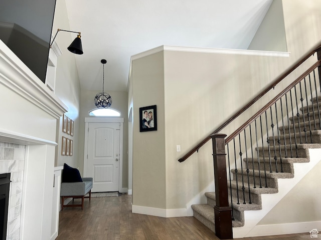 10124 S Autumn Breeze Ln W, South Jordan, UT 84009 - foyer featuring baseboards, a fireplace, stairway, dark wood-style floors, and high vaulted ceiling