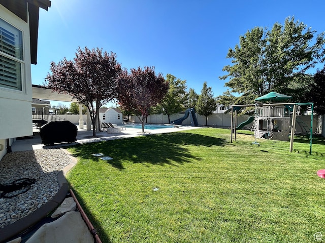 10124 S Autumn Breeze Ln W, South Jordan, UT 84009 - view of yard featuring a fenced in pool, a patio, a fenced backyard, and playground community