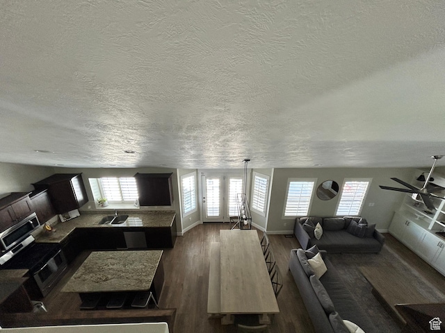 10124 S Autumn Breeze Ln W, South Jordan, UT 84009 - living area with a textured ceiling, baseboards, a ceiling fan, and wood finished floors
