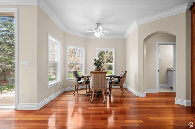 6041 S 2230 E, Holladay, UT 84121 - dining area featuring arched walkways, baseboards, light wood-style floors, a ceiling fan, and ornamental molding
