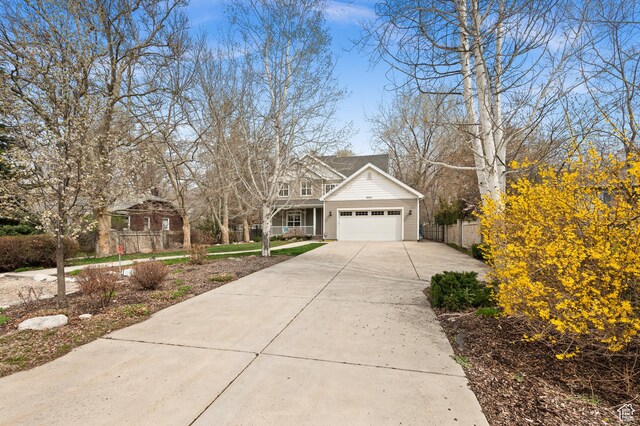 6041 S 2230 E, Holladay, UT 84121 - traditional-style home with fence, a garage, and concrete driveway