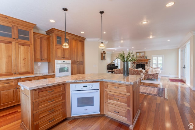 6041 S 2230 E, Holladay, UT 84121 - kitchen with a center island, open floor plan, white oven, and a fireplace