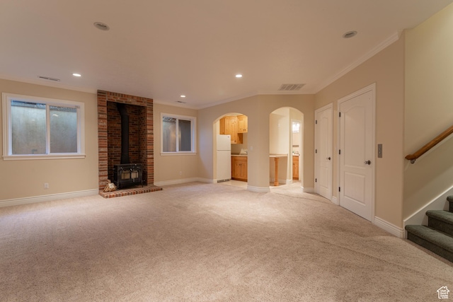6041 S 2230 E, Holladay, UT 84121 - unfurnished living room with visible vents, baseboards, light colored carpet, stairs, and a wood stove
