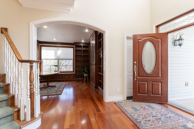 6041 S 2230 E, Holladay, UT 84121 - foyer entrance with stairway, ornamental molding, arched walkways, baseboards, and hardwood / wood-style flooring