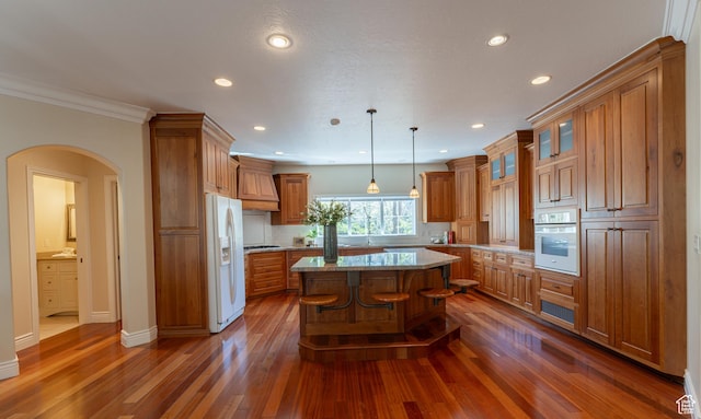 6041 S 2230 E, Holladay, UT 84121 - kitchen featuring brown cabinetry, a center island, white appliances, and recessed lighting