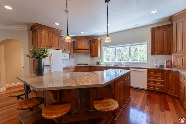 6041 S 2230 E, Holladay, UT 84121 - kitchen featuring brown cabinetry, tasteful backsplash, white appliances, and custom range hood