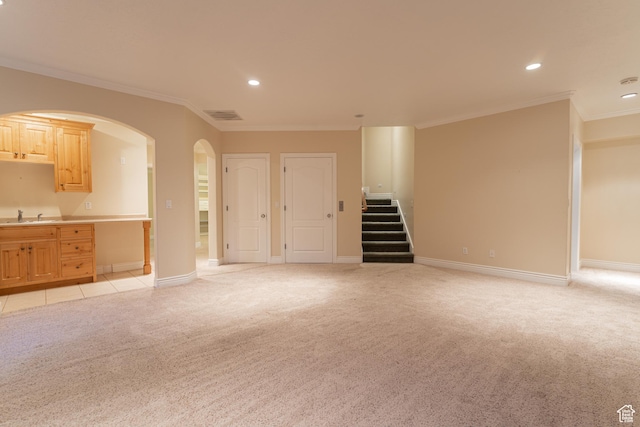 6041 S 2230 E, Holladay, UT 84121 - unfurnished living room with visible vents, stairs, a sink, crown molding, and light colored carpet