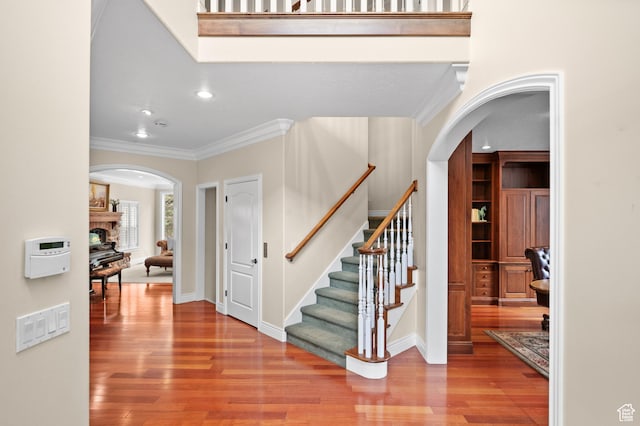 6041 S 2230 E, Holladay, UT 84121 - entrance foyer featuring stairway, wood finished floors, arched walkways, ornamental molding, and recessed lighting