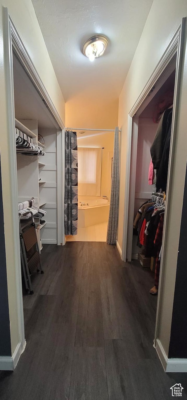 hall featuring baseboards and wood finished floors