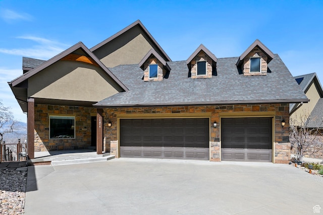 view of front of house featuring concrete driveway, an attached garage, stone siding, and a shingled roof