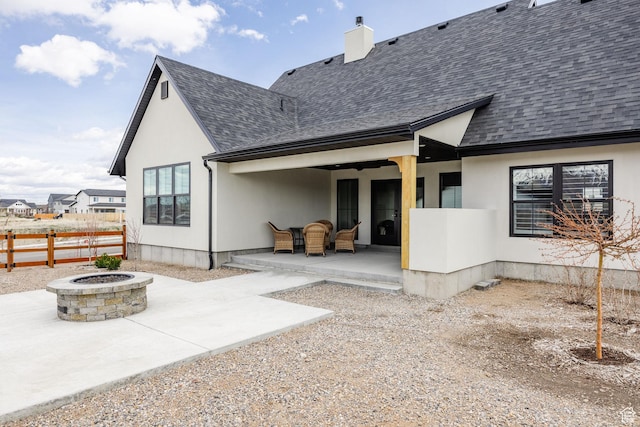 48 S 650 W, Hyrum, UT 84319 - back of house with a fire pit, a patio, a shingled roof, fence, and a chimney