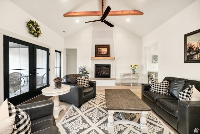 48 S 650 W, Hyrum, UT 84319 - living room with french doors, beamed ceiling, high vaulted ceiling, light wood-type flooring, and a fireplace