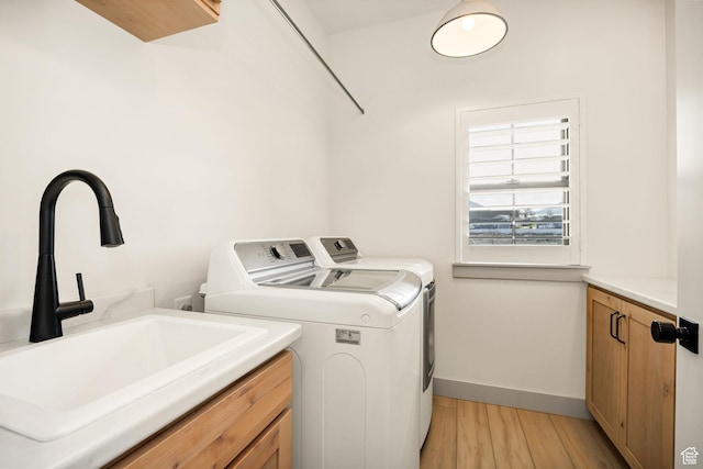 48 S 650 W, Hyrum, UT 84319 - laundry area featuring washing machine and clothes dryer, cabinet space, light wood-style flooring, and baseboards