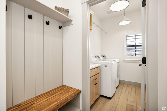 48 S 650 W, Hyrum, UT 84319 - laundry room with washer and clothes dryer, light wood-type flooring, cabinet space, and baseboards