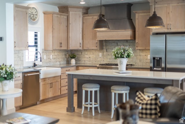 48 S 650 W, Hyrum, UT 84319 - kitchen featuring stainless steel appliances, a sink, light brown cabinets, and a breakfast bar area