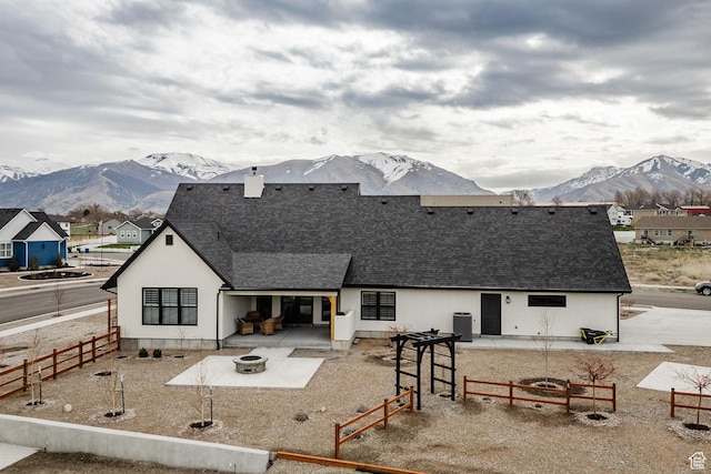 48 S 650 W, Hyrum, UT 84319 - rear view of house with a mountain view, an outdoor fire pit, roof with shingles, and a patio
