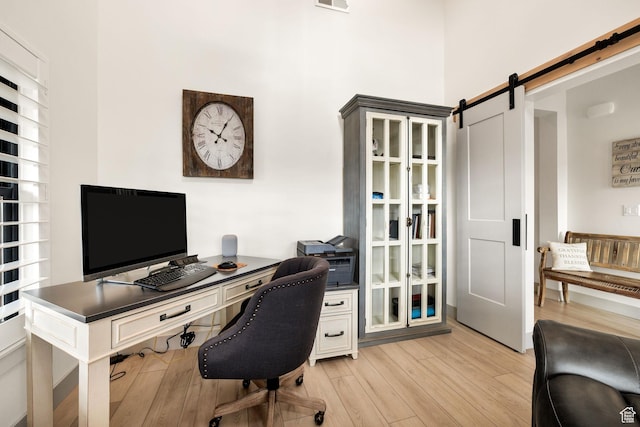 48 S 650 W, Hyrum, UT 84319 - home office with light wood-type flooring, a barn door, and a high ceiling