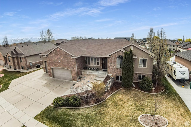 4781 W 4100 S, West Haven, UT 84401 - ranch-style house featuring brick siding, driveway, a residential view, a garage, and a front lawn