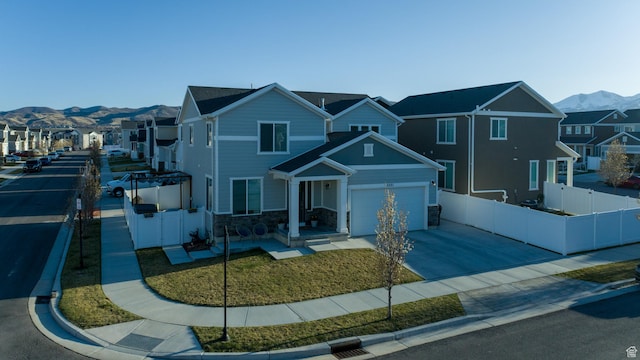5051 W Bilston Ln S, Herriman, UT 84096 - view of front of house featuring concrete driveway, a residential view, a mountain view, stone siding, and fence