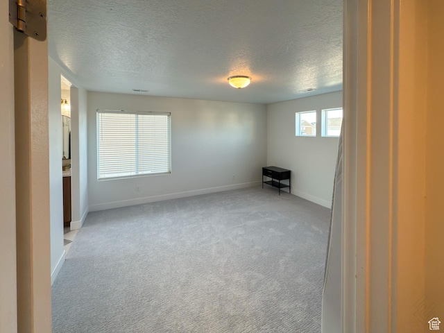 5051 W Bilston Ln S, Herriman, UT 84096 - spare room with baseboards, light colored carpet, and a textured ceiling