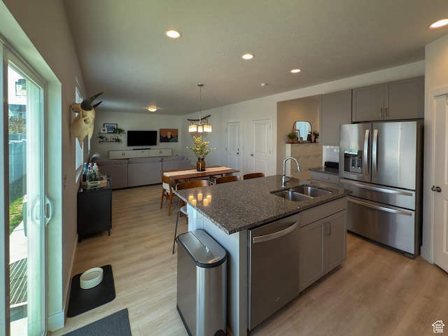 5051 W Bilston Ln S, Herriman, UT 84096 - kitchen with light wood-type flooring, dark stone countertops, recessed lighting, appliances with stainless steel finishes, and a sink