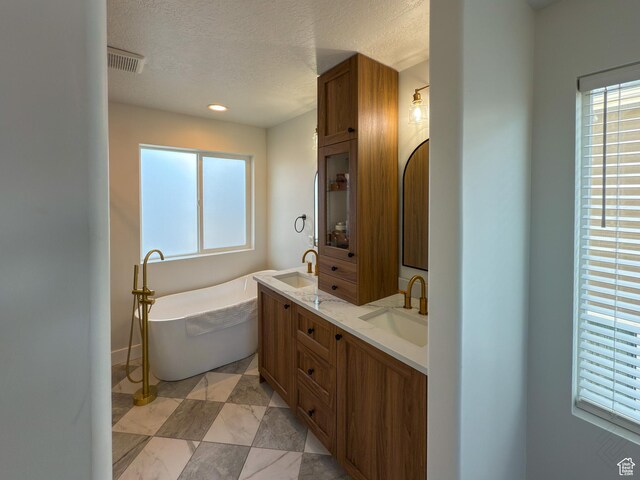 5051 W Bilston Ln S, Herriman, UT 84096 - full bath with a freestanding bath, double vanity, visible vents, and a sink