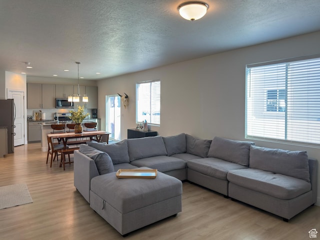 5051 W Bilston Ln S, Herriman, UT 84096 - living area with recessed lighting, light wood-style flooring, and a textured ceiling