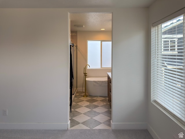 5051 W Bilston Ln S, Herriman, UT 84096 - full bathroom featuring visible vents, baseboards, a soaking tub, a textured ceiling, and vanity