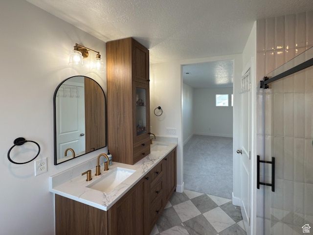 5051 W Bilston Ln S, Herriman, UT 84096 - bathroom with a sink, baseboards, double vanity, and a textured ceiling