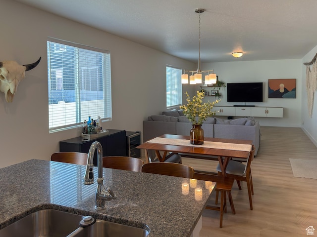 5051 W Bilston Ln S, Herriman, UT 84096 - dining room featuring baseboards, a notable chandelier, and light wood-style floors