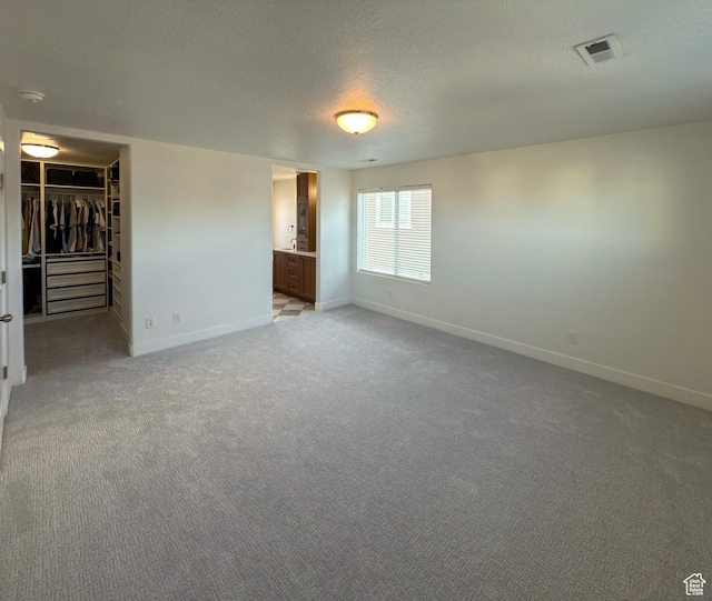 5051 W Bilston Ln S, Herriman, UT 84096 - empty room with light carpet, a textured ceiling, and baseboards