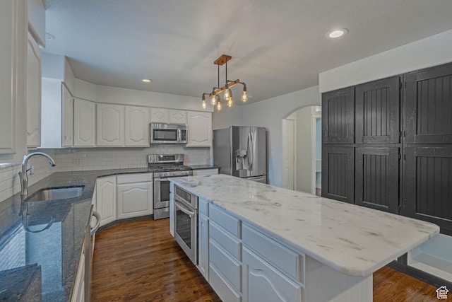 8079 S Juniper Ct, South Weber, UT 84405 - kitchen featuring a center island, white cabinets, a sink, light stone countertops, and stainless steel appliances