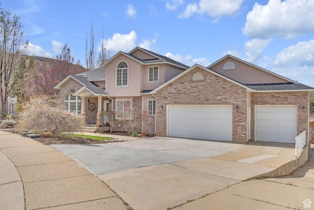 8079 S Juniper Ct, South Weber, UT 84405 - traditional home featuring brick siding, an attached garage, stucco siding, and concrete driveway