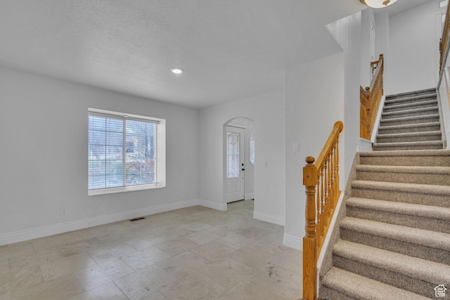 8079 S Juniper Ct, South Weber, UT 84405 - foyer entrance with baseboards, recessed lighting, stairs, visible vents, and arched walkways