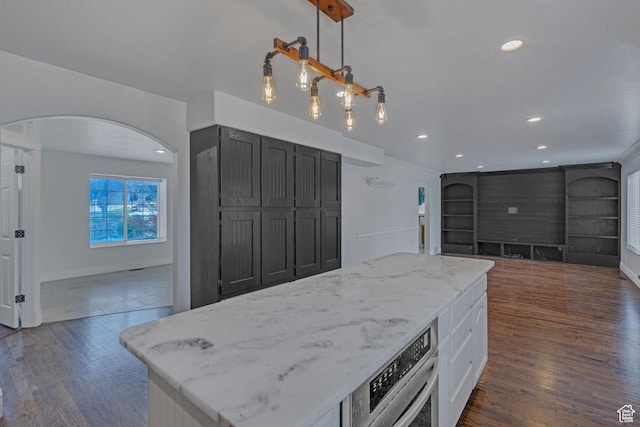 8079 S Juniper Ct, South Weber, UT 84405 - kitchen with light stone countertops, arched walkways, open floor plan, and dark wood-style floors