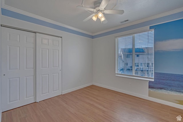8079 S Juniper Ct, South Weber, UT 84405 - unfurnished bedroom with visible vents, baseboards, a closet, crown molding, and wood finished floors