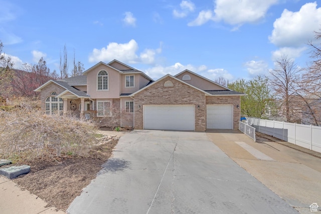 8079 S Juniper Ct, South Weber, UT 84405 - traditional-style house featuring an attached garage, fence, stucco siding, and concrete driveway